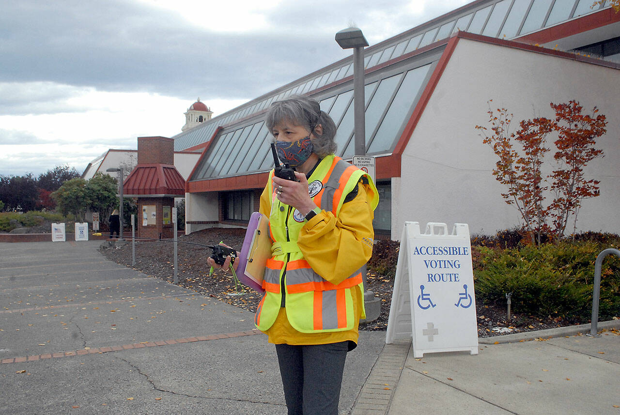 Ham radio operator Kathleen Reiter, training coordinator for Amateur Radio Emergency Services, relays radio messages outside the county courthouse during Thursday’s Great ShakeOut, an international drill to practice how to drop, cover and hold in the event of an earthquake. In Clallam County, numerous schools and other agencies practiced what to do in an emergency. Included in the drill was the sounding of tsunami sirens across the state. (Keith Thorpe/Peninsula Daily News)