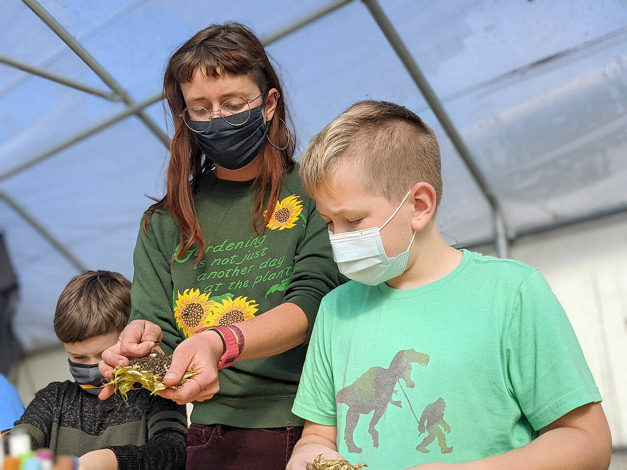 Educator Carrie Walker works with students in Quilcene at the school garden, one of the locations supported by the Jefferson County Community Wellness Project. The project, which has its dinner-and-a-movie event Thursday, connects local schools, gardens and farms. photo courtesy Community Wellness Project
