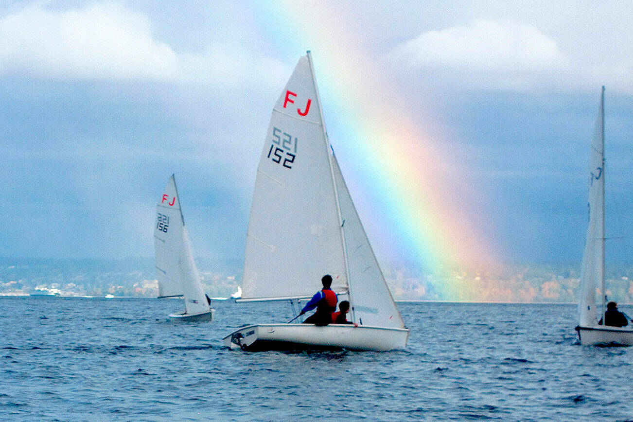 Port Angeles High School sailing team members Elliot Dahlin and Fern Knobel (152), sail at a regional scrimmage this weekend off Kingston as a rainbow comes out. Teammates Ozzy Minard and Ella Schulz are in boat 156. (Courtesy of Perry Brestel)