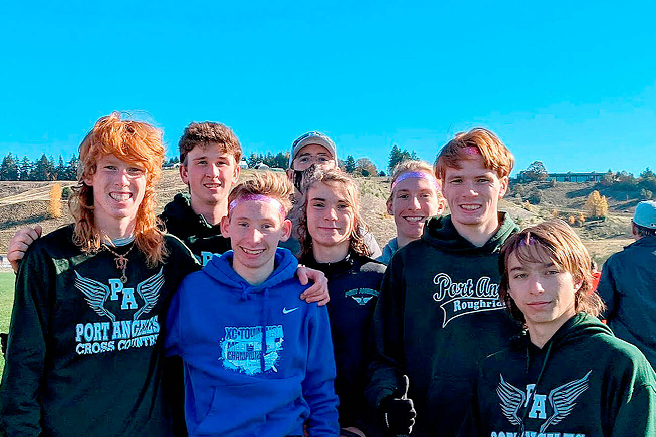 The Port Angeles cross country team, from left Jack Gladfelter, Naaman McGuffey, Langdon Larson, Coach Rodger Johnson, Kowen Kasten, Josh Gavin, Jason Gladfelter and Max Baeder, took first place at district.