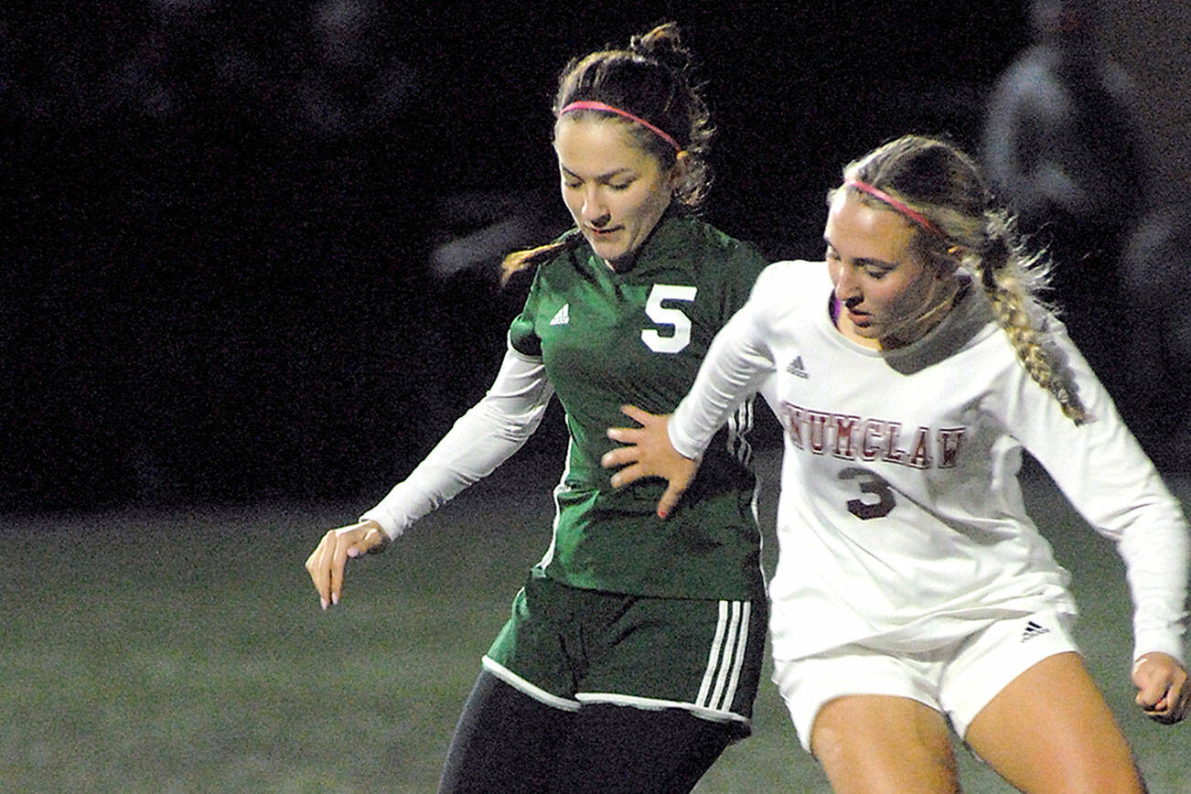 Keith Thorpe/Peninsula Daily News
Port Angeles' Mia Gagnon, left, and Enumclaw's Lauren Boger battle for the ball during Tuesday night's playoff game at Wally Sigmar Field in Port Angeles.