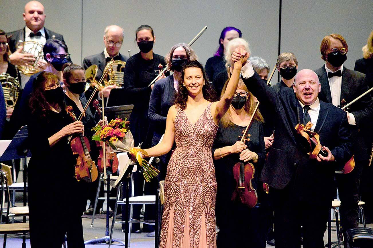 Guest soloist Anna Petrova and conductor Jonathan Pasternack take their bows following Saturday’s Port Angeles Symphony Orchestra concert. The ensemble returned to the Port Angeles High School Performing Arts Center this past weekend for the first time in 20 months; its next concert is set for Dec. 11. (Diane Urbani de la Paz/Peninsula Daily News)