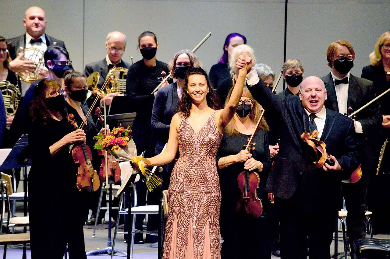 Guest soloist Anna Petrova and conductor Jonathan Pasternack take their bows following Saturday’s Port Angeles Symphony Orchestra concert. The ensemble returned to the Port Angeles High School Performing Arts Center this past weekend for the first time in 20 months; its next concert is set for Dec. 11. (Diane Urbani de la Paz/Peninsula Daily News)