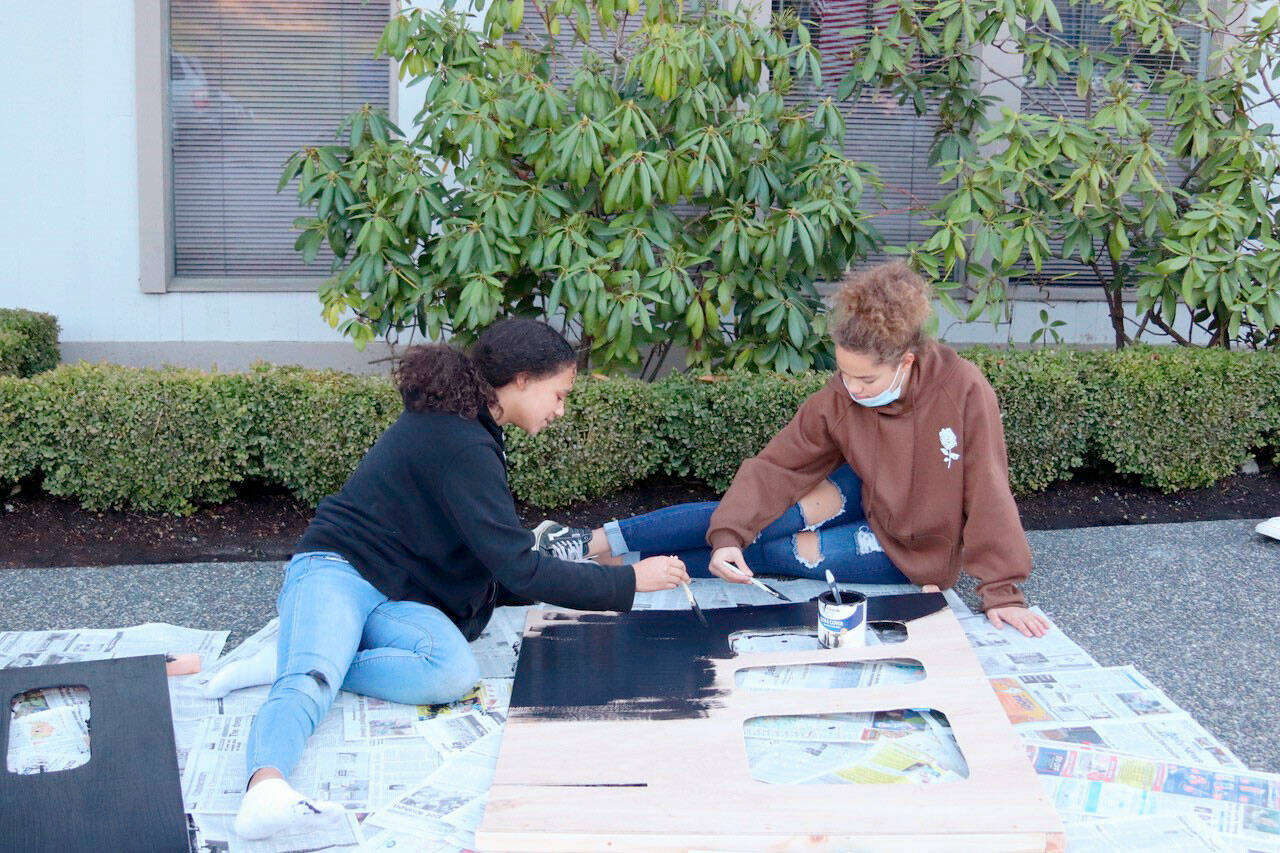 Teen leaders Ava Hubbard, of Port Townsend, on the left, and Briangela Vanwart, of Sequim, paint scenery in preparation for the Rocky Railroad Kids’ Night	(Nathan Byers/Sequim Adventist Church)