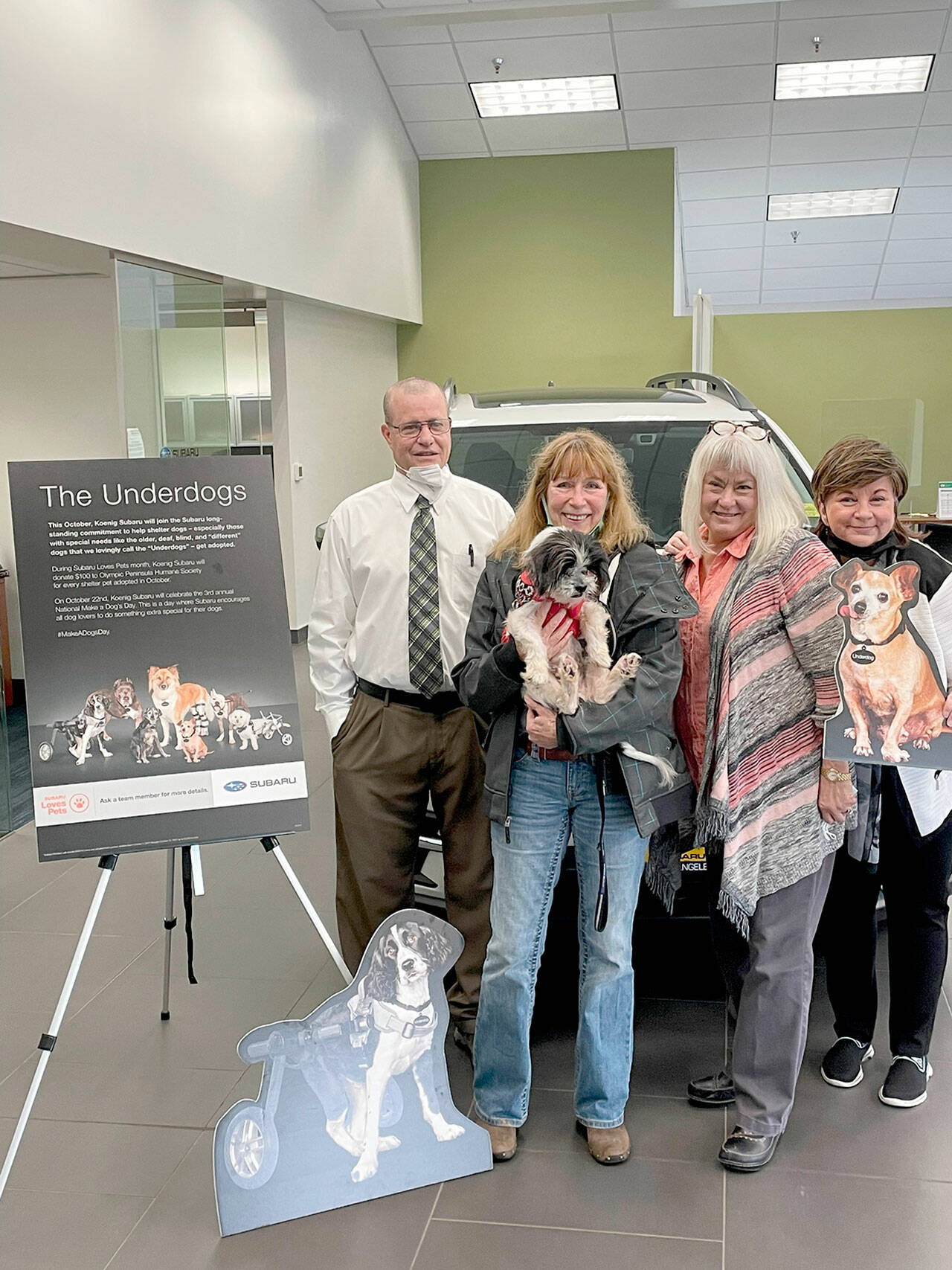 Pictured, from left to right, are Ken Cardella, Patty Mendenwald with Winnie, Nadean Portner, and Luann Hinkle, executive director of Olympic Peninsula Humane Society.