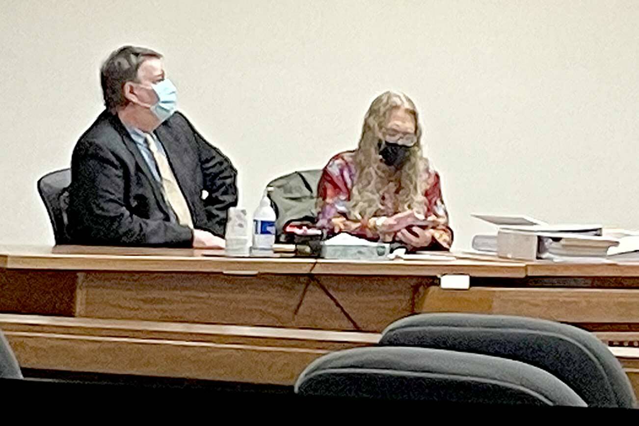Dennis Bauer, left, consults with attorney Karen Unger on Monday during opening statements. Bauer is charged with three counts of aggravated first-degree murder. (Rob Ollikainen/for Peninsula Daily News)