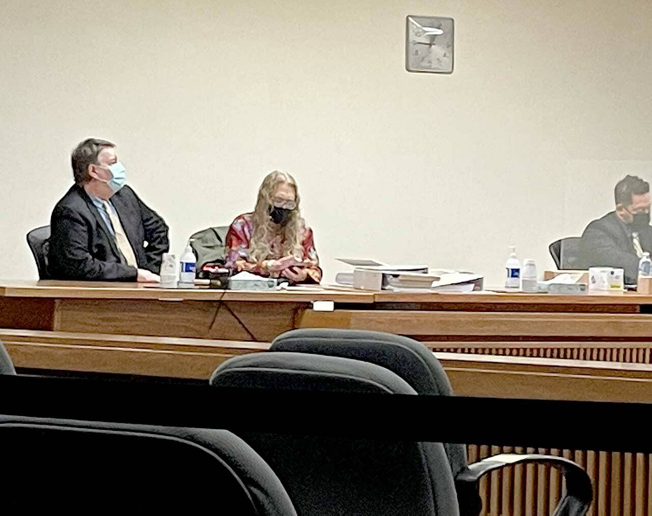 Dennis Bauer, left, consults with attorney Karen Unger on Monday during opening statements. Bauer is charged with three counts of aggravated first-degree murder. (Rob Ollikainen/for Peninsula Daily News)