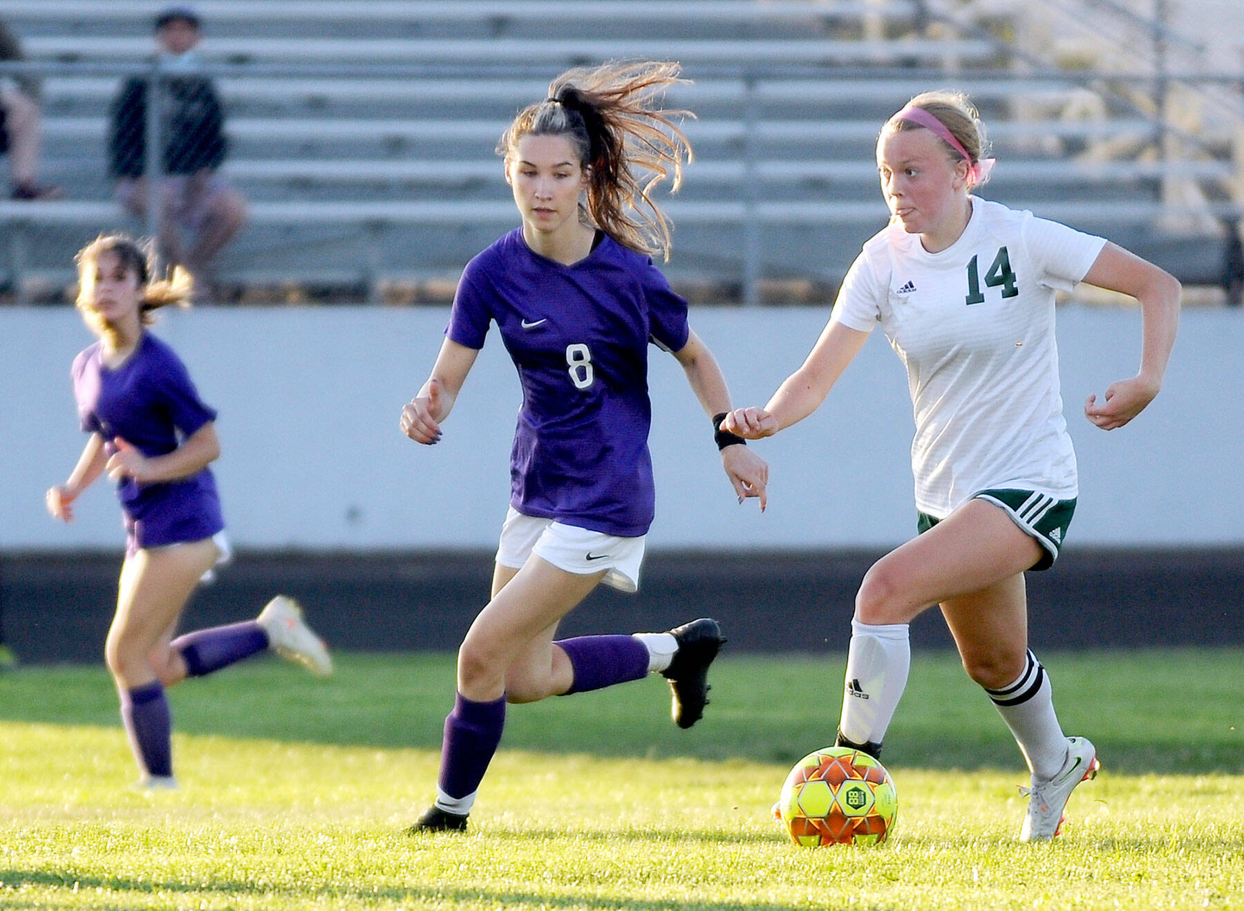 Port Angeles’ Anna Petty (14) looks upfield as she dribbles against Sequim’s Zoe Moore. Petty, the Roughriders’ lockdown defensive central midfielder, is the All-Peninsula Girls Soccer MVP. (Michael Dashiell/Olympic Peninsula News Group)