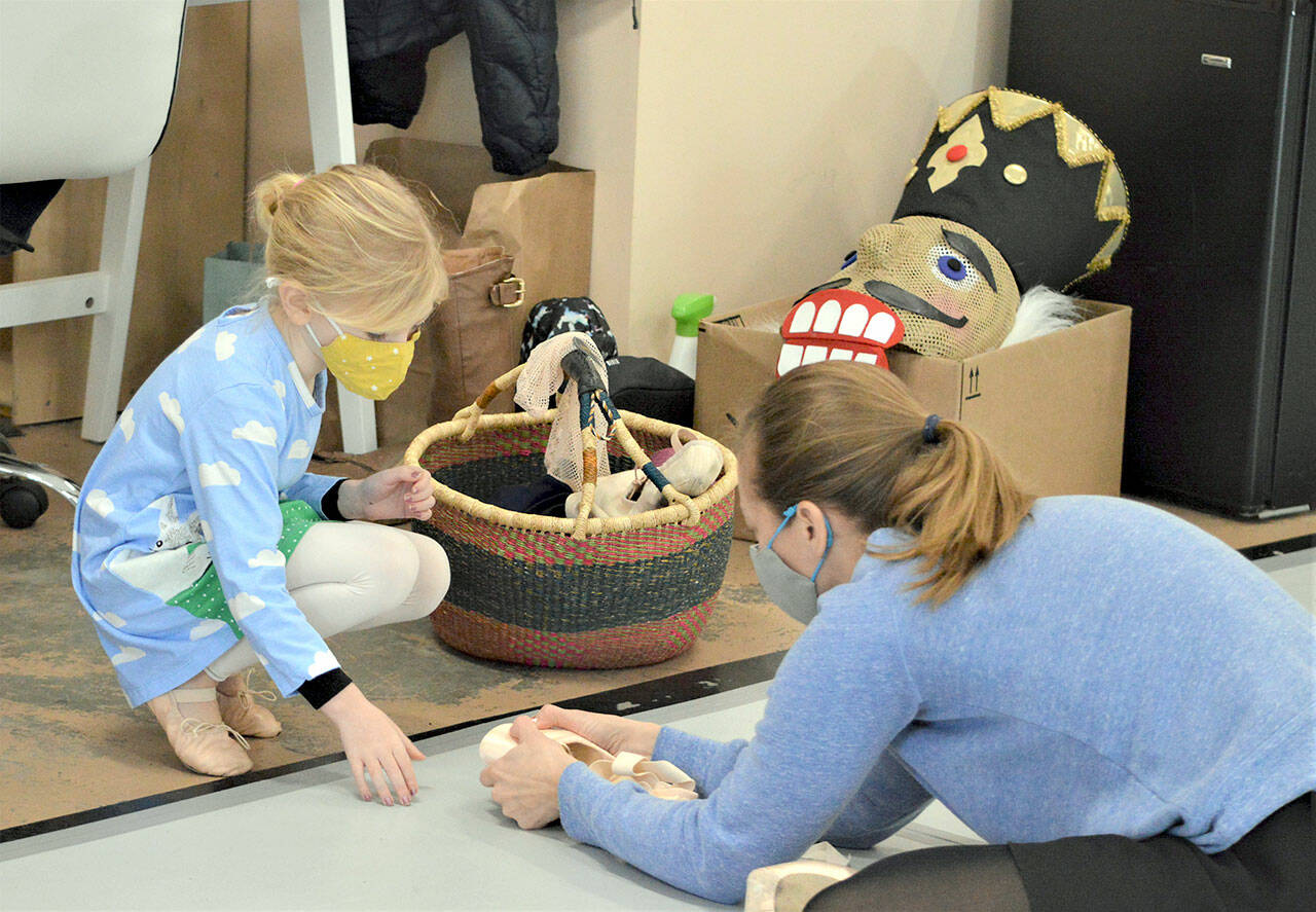 Port Townsend Ballet teacher Krystal Kennedy shows student Soleil Robinson, 6, her toe shoes after class Tuesday afternoon. In the PTB’s “The Nutcracker” next week, Kennedy will dance the roles of the Snow Queen and Dew Drop Fairy. (Diane Urbani de la Paz/Peninsula Daily News)