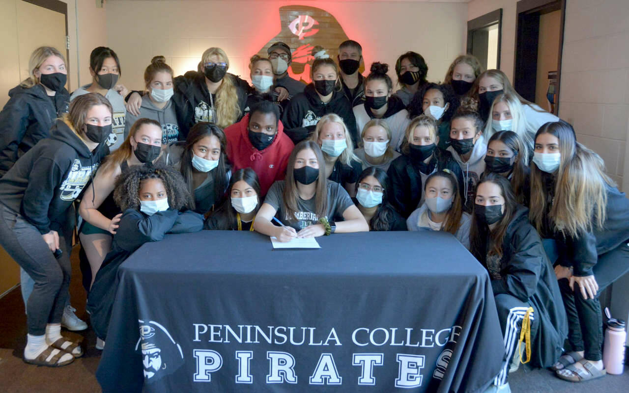 Peninsula College
Peninsula College's Grace Johnson, center, signs to play women's soccer for Humboldt State University in Arcata, Calif., late last week surrounded by her Pirates teammates after her team won the NWAC championship.
