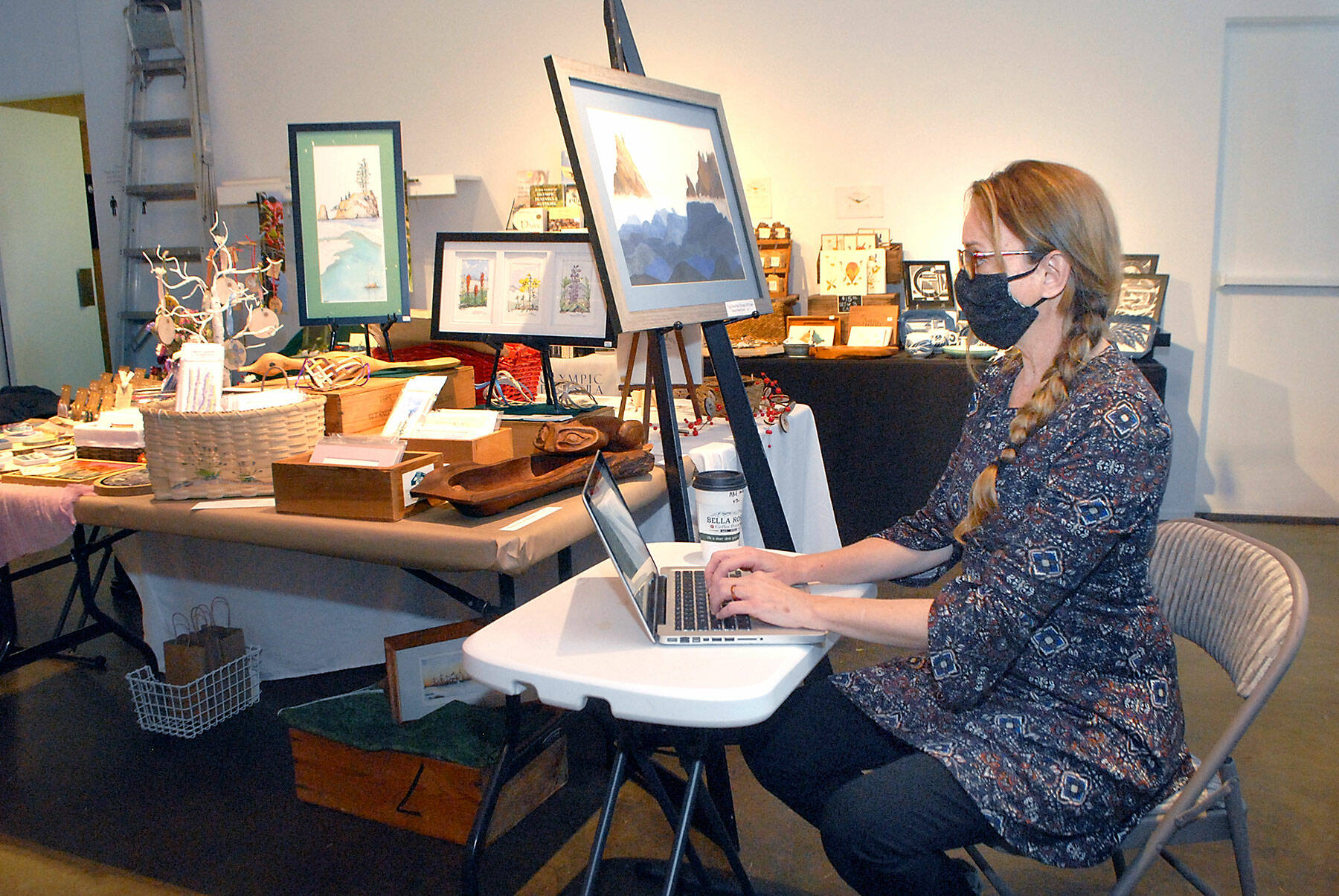 Port Angeles artist Sarah Tucker takes an inventory of items made by area artisans that will be available for sale at the Wintertide Makers Market at the Port Angeles Fine Arts Center. (Keith Thorpe/Peninsula Daily News)