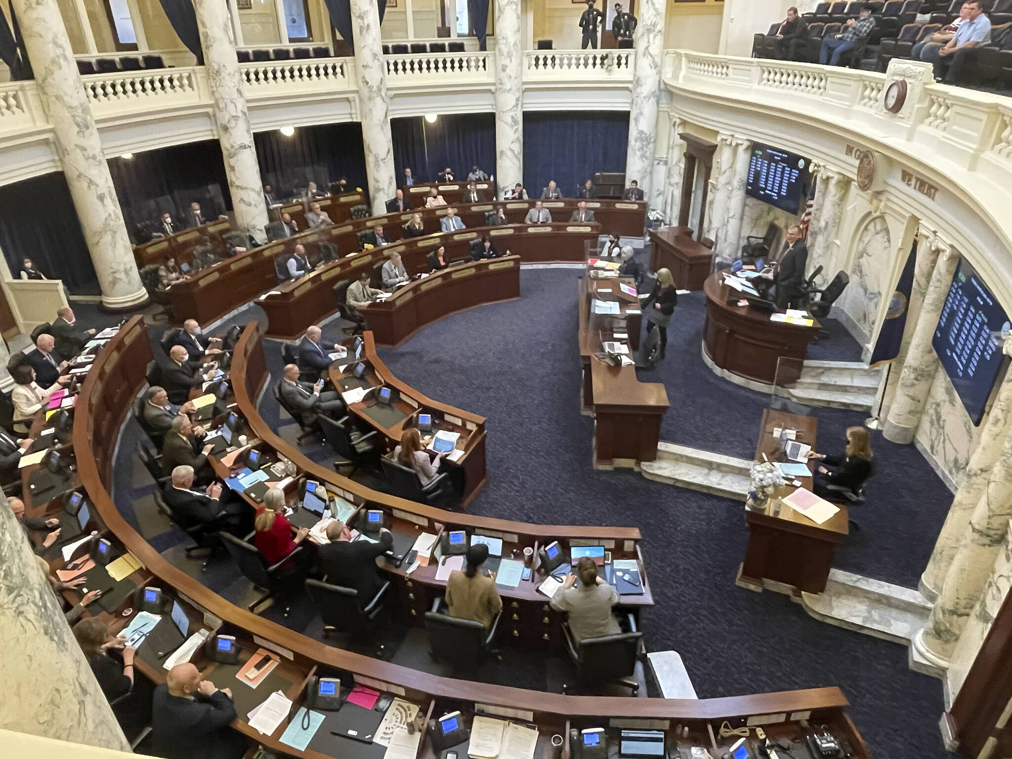 FILE - In this March 9, 2021, file photo, House members meet in the Statehouse, in Boise, Idaho. An Idaho law banning nearly all abortions would take effect if the U.S. Supreme Court overturns Roe v. Wade, the landmark 1973 ruling that declared a nationwide right to abortion. The court with a 6-3 conservative majority on Wednesday, Dec. 1 starts hearing arguments over a Mississippi law that bans abortions after 15 weeks. (AP Photo/Keith Ridler, File)