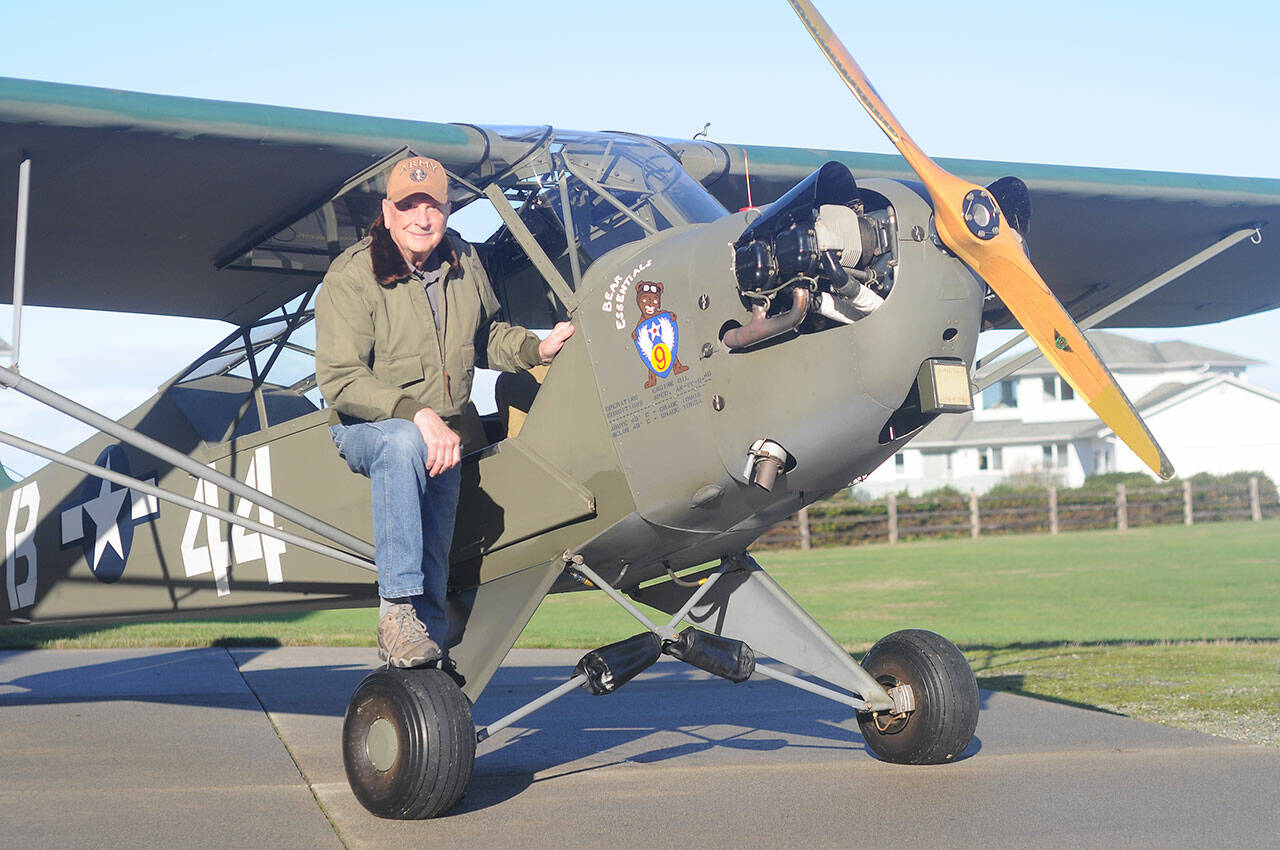 Sequim pilot and veteran David Woodcock stands near his 1944 Piper Cub L-4H, an aircraft that saw action at the Battle of the Bulge. (Michael Dashiell/Olympic Peninsula News Group)