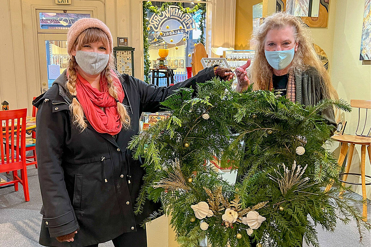 Port Townsend Main Street Program

 Eryn Smith, on left, presents a gold award to JoAnn Williams for the window at Earthenworks Gallery.