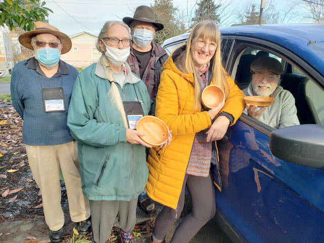 From left, John Elliott, Jackie Ledoux, Tracy McCallum, Jackie Miller and John Miller show the bowls crafted by local woodworkers.