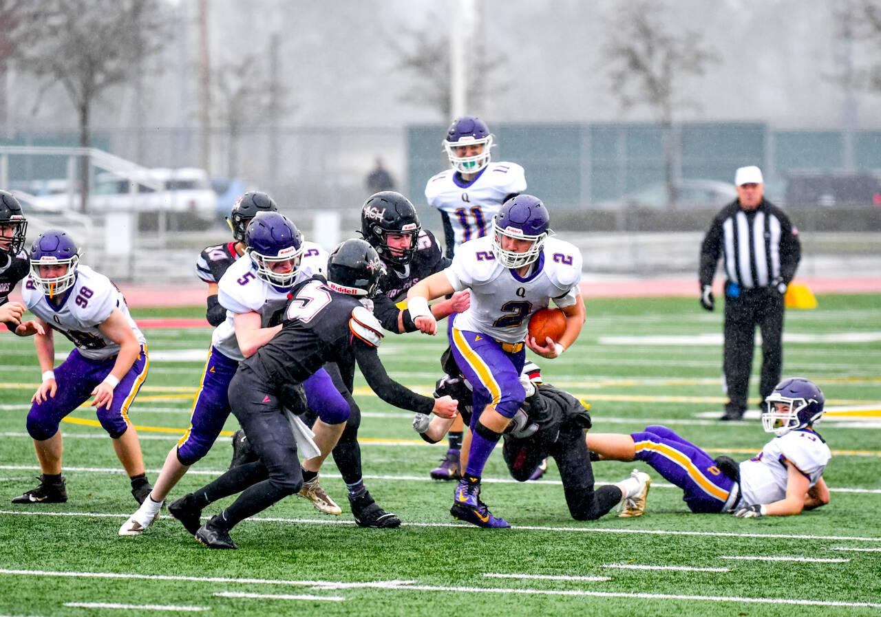 Jim Wilkerson/for Peninsula Daily News Quilcene’s Bishop Budnek runs the ball against Almira-Coulee-Hartline in the 1B state football championship at Mount Tahoma High School on Saturday. ACH won 50-20. Also in on the play are Quilcene’s Maxx Budnek (98), Dominic Smith (5) and Nathan Kieffer (11).