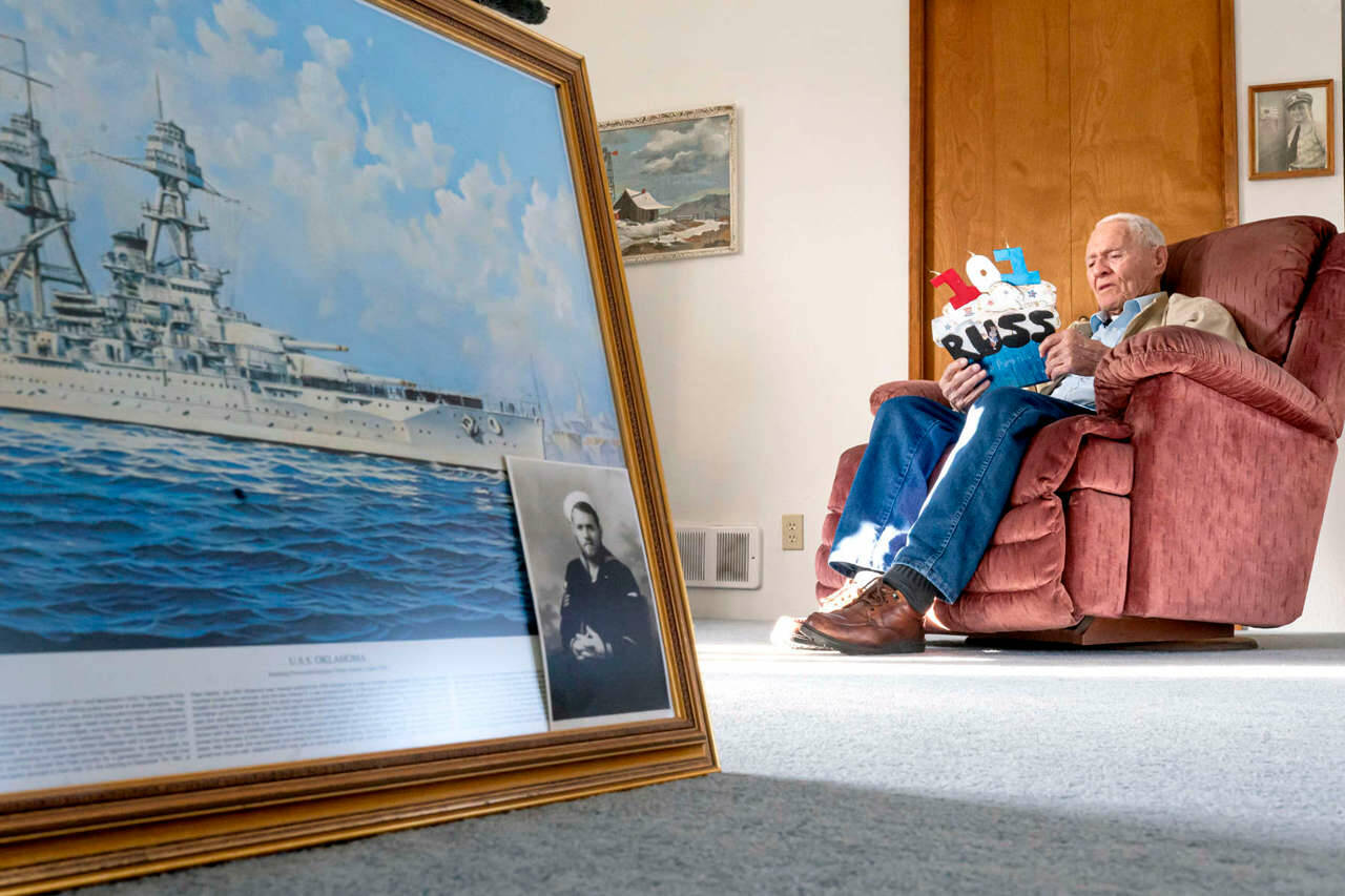 Pearl Harbor survivor and World War II Navy veteran David Russell, 101, reads a birthday card in Albany, Ore., while talking about his time aboard the USS Oklahoma and his life after the war. (Nathan Howard/The Associated Press)