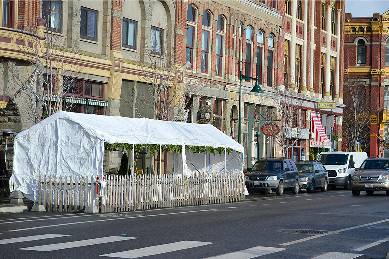 The Old Whiskey Mill’s tent on Water Street in Port Townsend is one of four “streateries” now permitted to stay up through Mother’s Day 2022. The outdoor dining enclosures, first allowed in mid-2020, have been given four extensions. (Diane Urbani de la Paz/Peninsula Daily News)