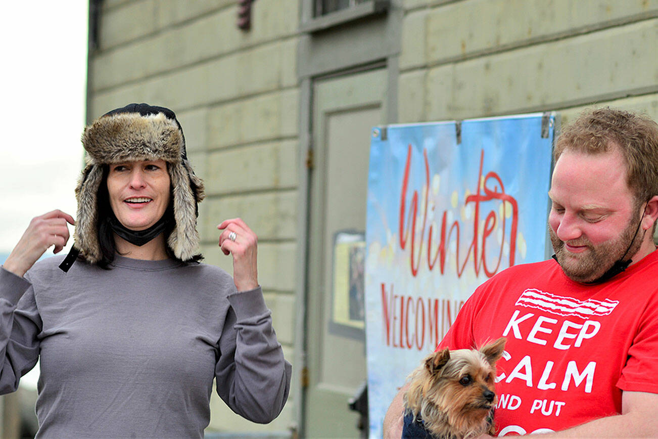 Lisa Anderson and Ben Casserd, along with Half Pint, their terrier mix, are the staff monitors at the Winter Welcoming Center. The center offers warmth, coffee, snacks, wi-fi and electricity for charging devices in the Pope Marine Building at Water and Madison streets in Port Townsend. Diane Urbani de la Paz/Peninsula Daily News