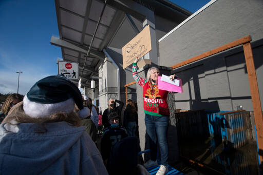 Jesse Major / for Peninsula Daily News
Val Brooks, Clallam County Child Advocates program coordinator, makes an announcement at the start of the third annual Shop With a Roughneck/Cop event at Walmart in Port Angeles. Law enforcement personnel from local, state and federal agencies, as well as members of The Roughnecks, a local motorcycle club of active and retired law enforcement, military and public safety personnel, took about 90 Clallam County children involved in state or tribal dependency cases on a $100 shopping spree ahead of Christmas last Saturday. Walmart donated $3,500 for the event.