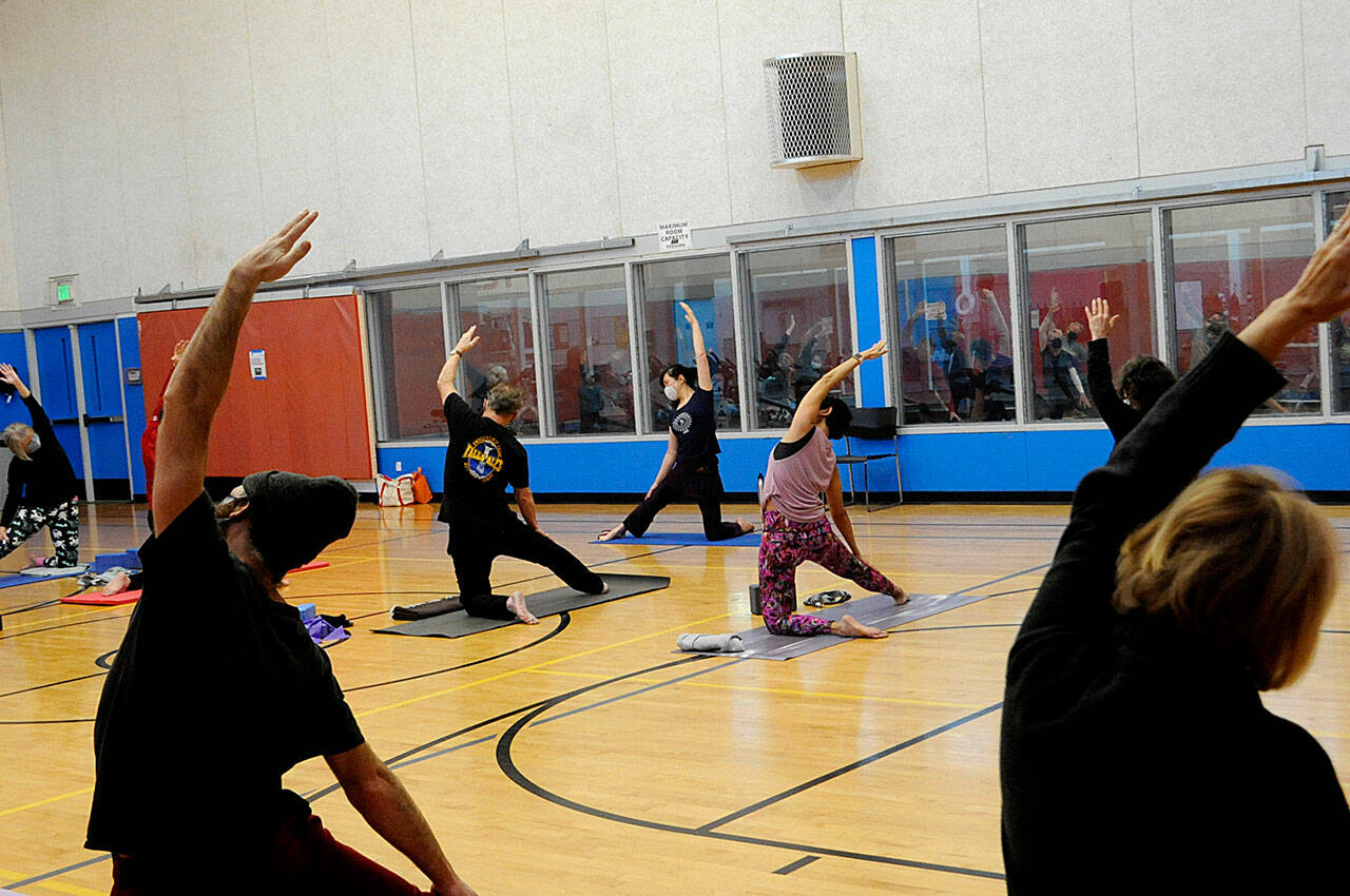 Kitty Sokkappa leads a yoga class at the YMCA of Sequim. It’s one of the biggest at the facility, staff say. Starting Jan. 1, club members and participants ages 12 and older in all North Olympic Peninsula YMCAs must provide proof of COVID-19 vaccine or a negative test before participating in events. (Matthew Nash/Olympic Peninsula News Group)