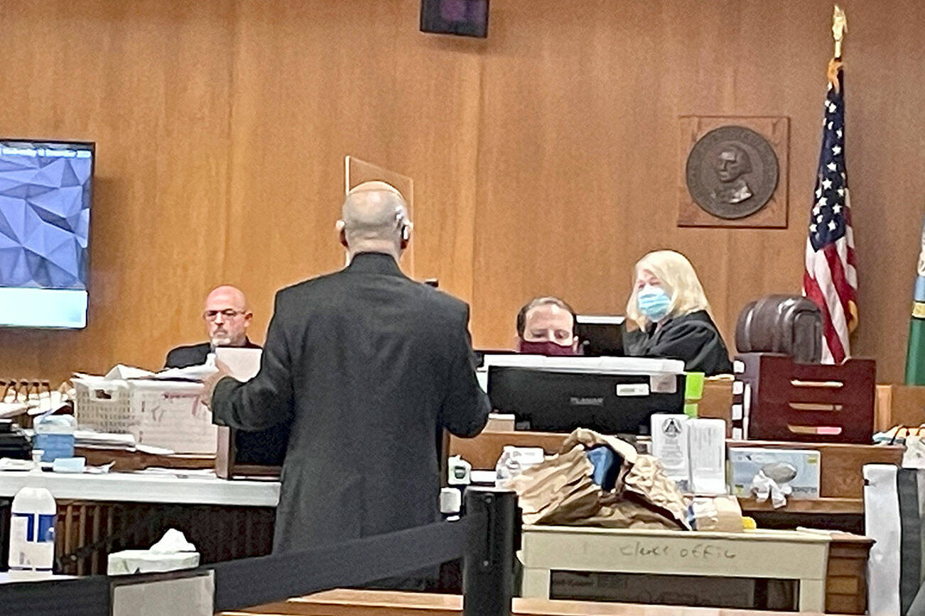 State Patrol Detective Michael Grall, left, is questioned by Clallam County Deputy Prosecuting Attorney Jesse Espinoza in Dennis Marvin Bauer’s triple-murder trial in Clallam County Superior Court. (Rob Ollikainen/for Peninsula Daily News)