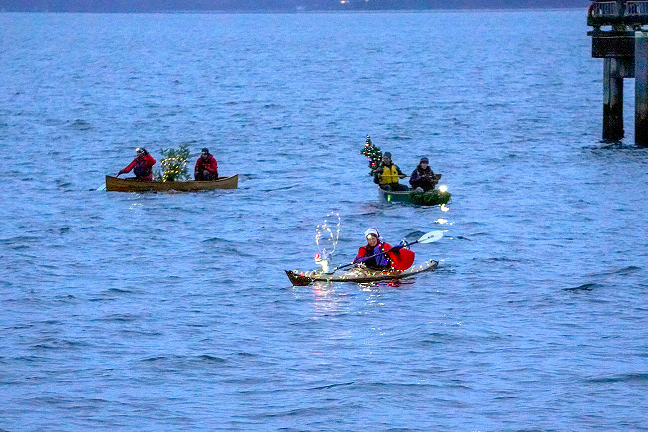 Steve Mullensky/for Peninsula Daily News


The three entrants in the non-motorized class of the holiday boat parade pass by the waterfront at Adams Street in downtown Port Townsend on Friday.