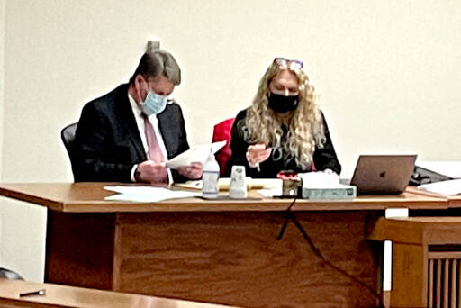 Dennis Marvin Bauer, left, speaks with his attorney, Karen Unger, before testimony in his triple-murder trial Monday at the Clallam County Courthouse. (Rob Ollikainen/For Peninsula Daily News)