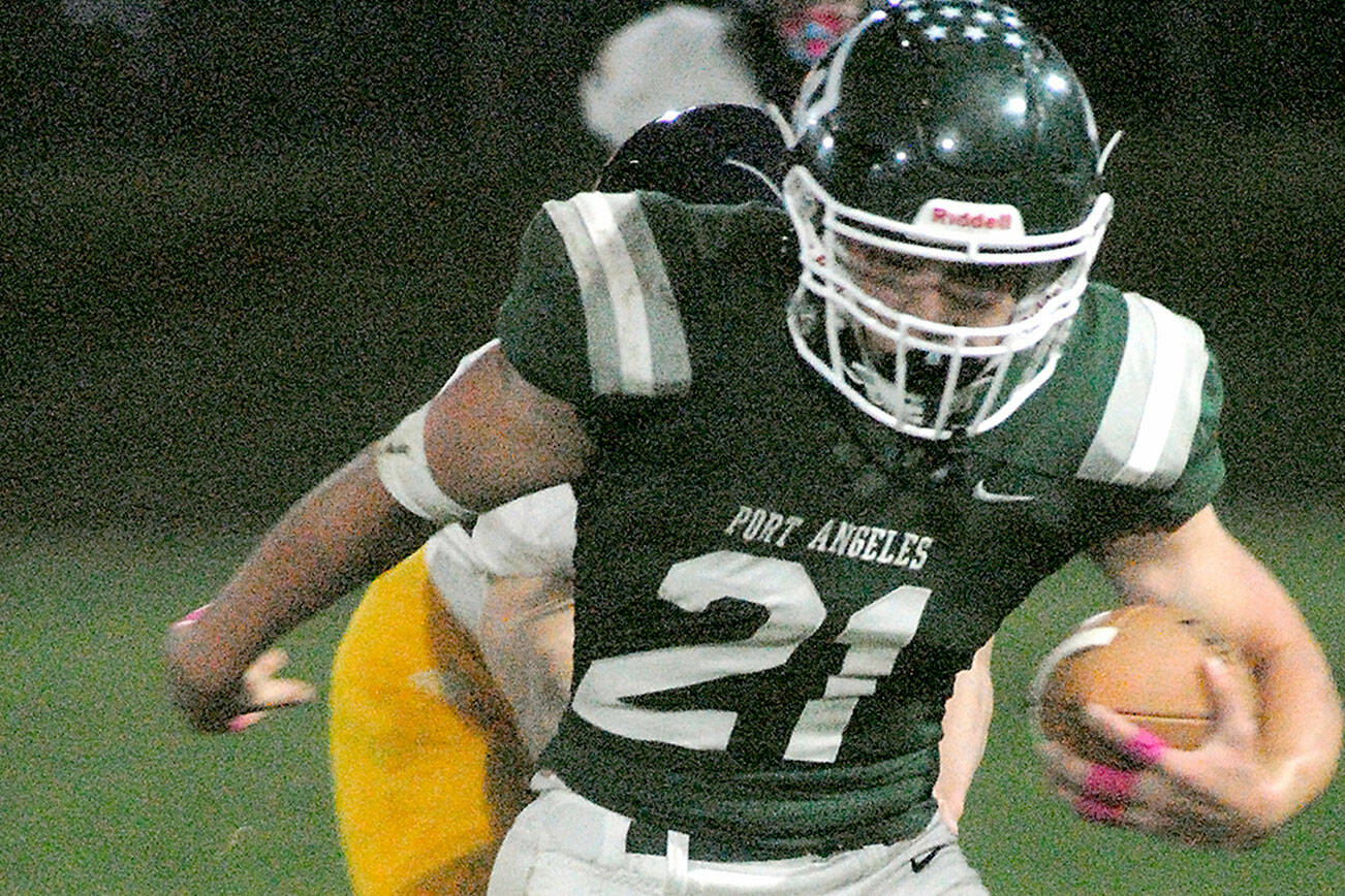 Keith Thorpe/Peninsula Daily News
Port Angeles' Daniel Cable escapes the Bainbridge defense on Friday night at Port Angeles Civic Field.