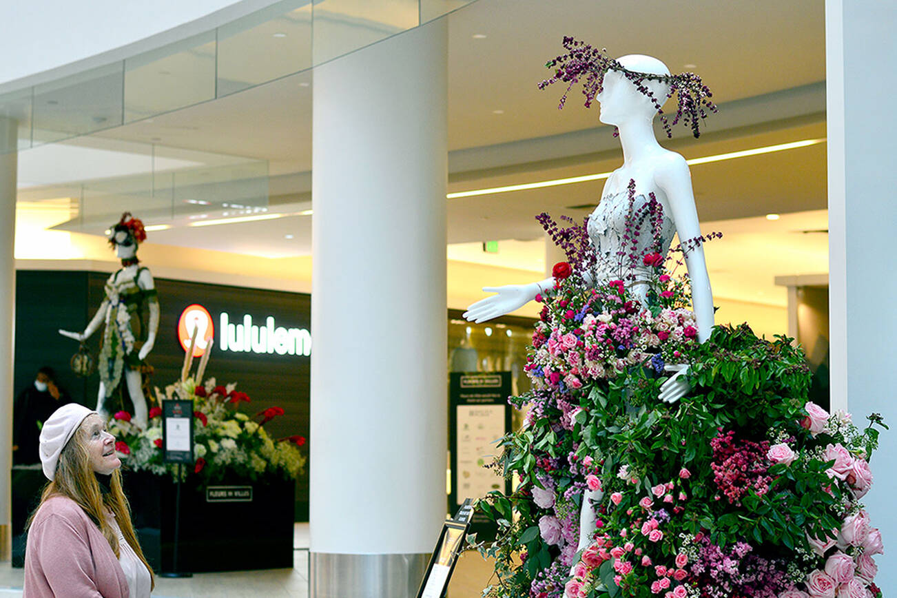 Sid Anna Sherwood, owner of Annie’s Flower Farm in Sequim, created “Flora,” goddess of blooming flowers, for the Fleurs de Villes show at Pacific Place in Seattle. The 18-piece display stays up through Monday. (Diane Urbani de la Paz/Peninsula Daily News)