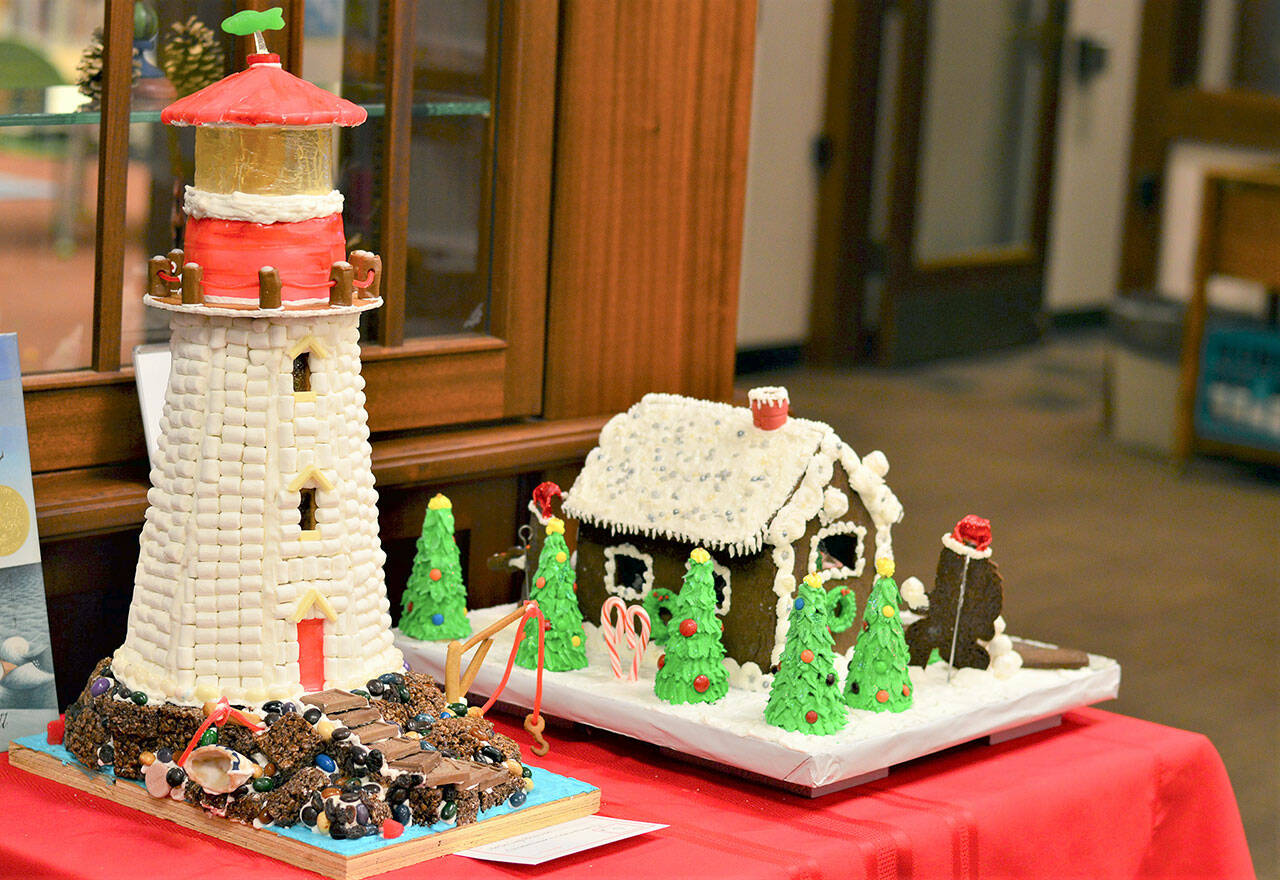 Two literary gingerbread houses, one inspired by Sophie Blackall’s book “Hello Lighthouse” and one titled “The Sasquatch Who Stole Christmas,” are among the 18 edible edifices on display at the Port Townsend Library, 1220 Lawrence St. For details about the Uptown Gingerbread Contest, which will accept its last entries on Tuesday, see ptpubliclibrary.org. (Diane Urbani de la Paz/Peninsula Daily News)