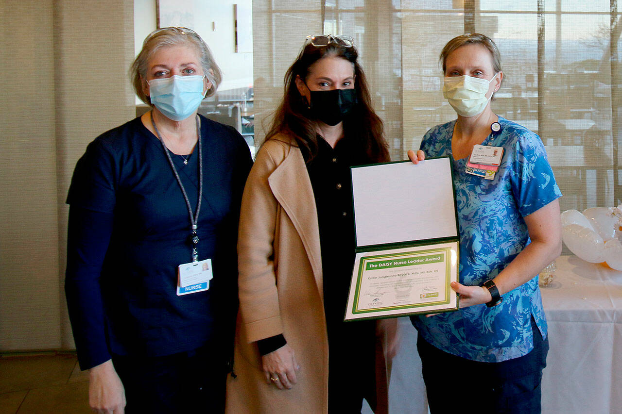 Katrin Junghanns-Royack, Olympic Medical Center’s director of ICU/telemetry, right, was recently honored as the department’s first recipient of the DAISY Nurse Leader Award. Presenting her the award is Chief Nursing Officer Vickie Swanson, center, and ICU/telemetry clinical supervisor Janeen Howell, ICU/telemetry clinical supervisor. (Photo courtesy of Olympic Medical Center)