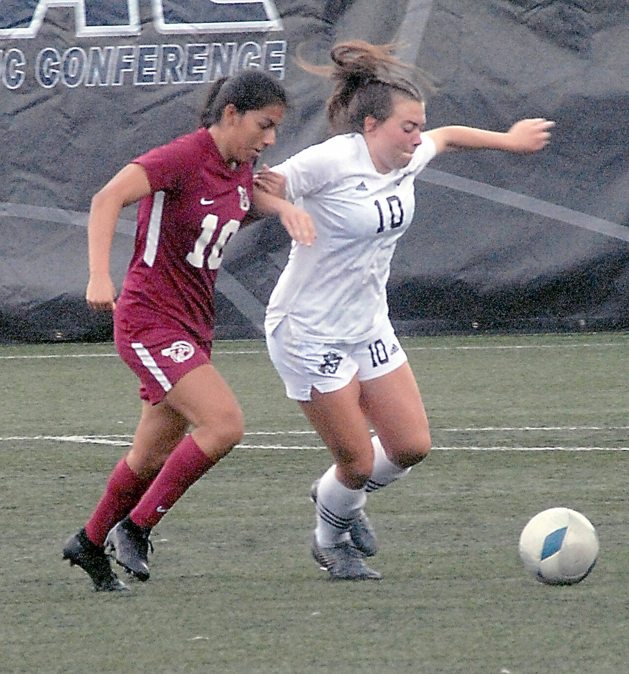 Pierce’s Regina Garay, left, and Peninsula’s Grace Johnson chase a loose ball on Saturday in Port Angeles. (Keith Thorpe/Peninsula Daily News)