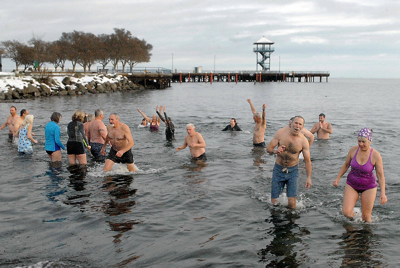 Keith Thorpe/Peninsula Daily News
Polar bear dippers wade in and out of the chilly water at Hollywood Beach in Port Angeles during Saturday's annual New Year's Day plunge.  Dozens of people braved sub-freezing air temperatures to ltake part in the ritual that also was undertaken by others on the North Olympic Peninsula at Lake Pleasant and Nordland.