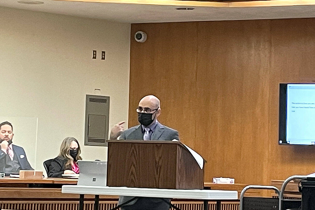 Rob Ollikainen/for Peninsula Daily News
Clallam County Deputy Prosecuting Attorney Jesse Espinoza makes a closing argument in Dennis Marvin Bauer’s triple-murder trial in Clallam County Superior Court on Wednesday. Sheriff’s Sgt. Jeff Waterhouse and Chief Criminal Deputy Prosecuting Attorney Michele Devlin look on.