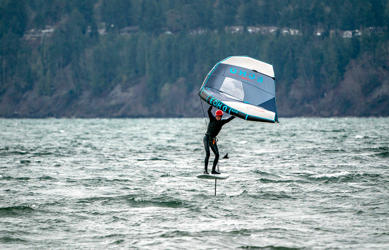 A wing-foiler hones his skills on windy Port Townsend Bay. The forecast calls for more seasonal temperatures this week with highs in the mid- to upper 40s and lows in the high 30s. (Steve Mullensky/for Peninsula Daily News)