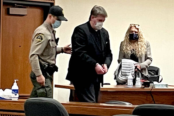 Dennis Marvin Bauer is escorted out of Clallam County Superior Court after he was convicted of a 2018 triple murder on Monday. (Rob Ollikainen/for Peninsula Daily News)