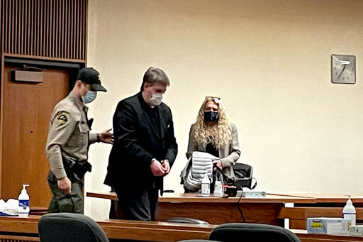 Dennis Marvin Bauer is escorted out of Clallam County Superior Court after he was convicted of a 2018 triple murder on Monday. (Rob Ollikainen/for Peninsula Daily News)