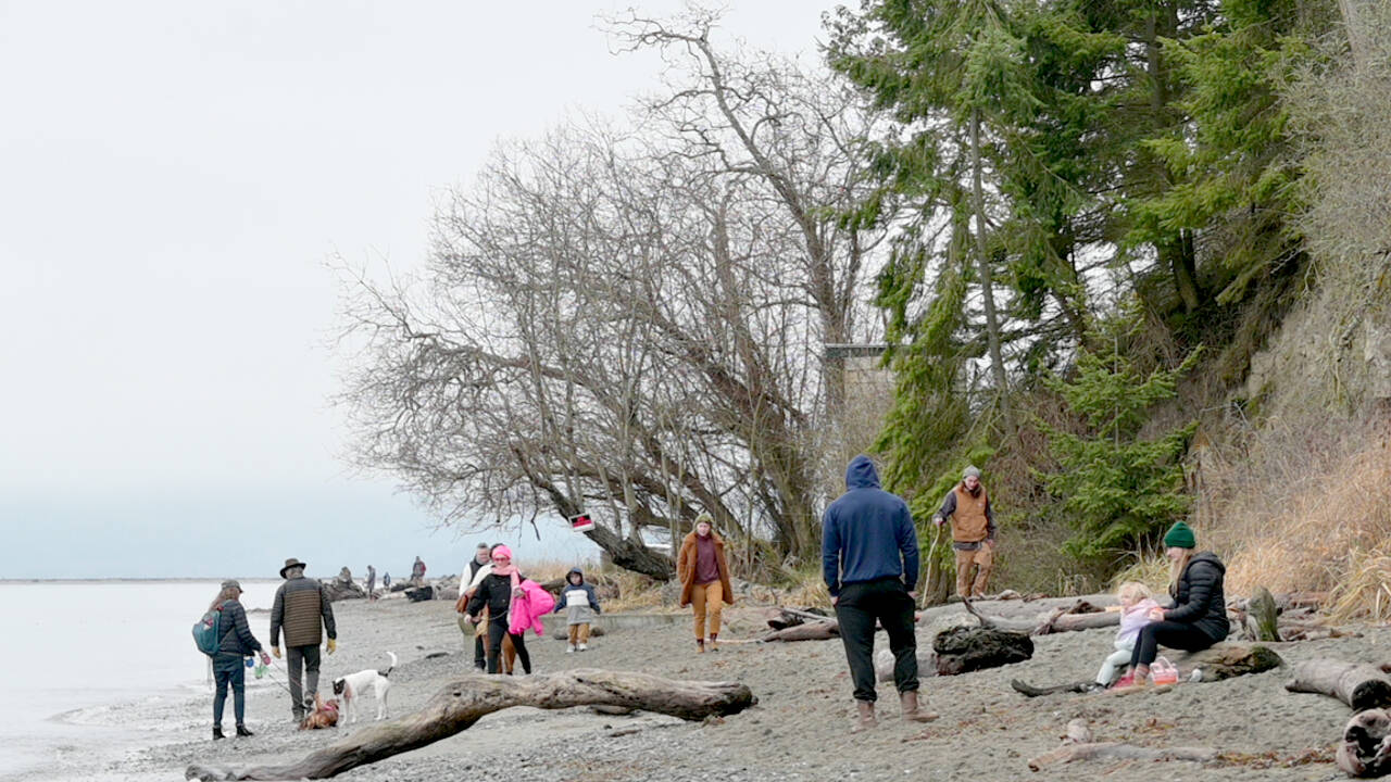 Port Williams Beach, north of Sequim, proved to be a popular destination for strollers and dog walkers Sunday with cloudy skies but temperatures in the high 40s. Tomorrow, weather forecasters are calling for 50 percent of showers and temperatures in the low to mid-40s. (Paul Gottlieb/Peninsula Daily News)