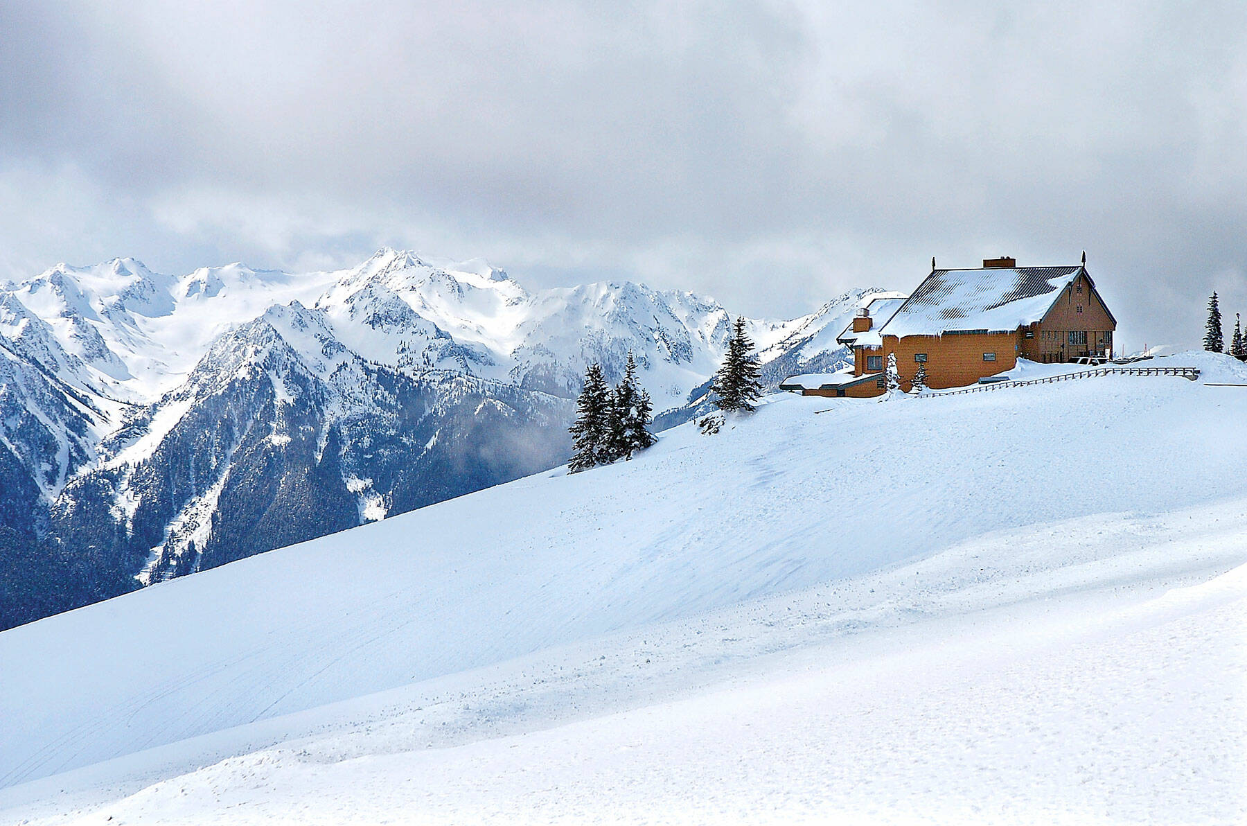 Snow-covered mountains surround the Hurricane Ridge Visitor Center in 2009. (Peninsula Daily News)
