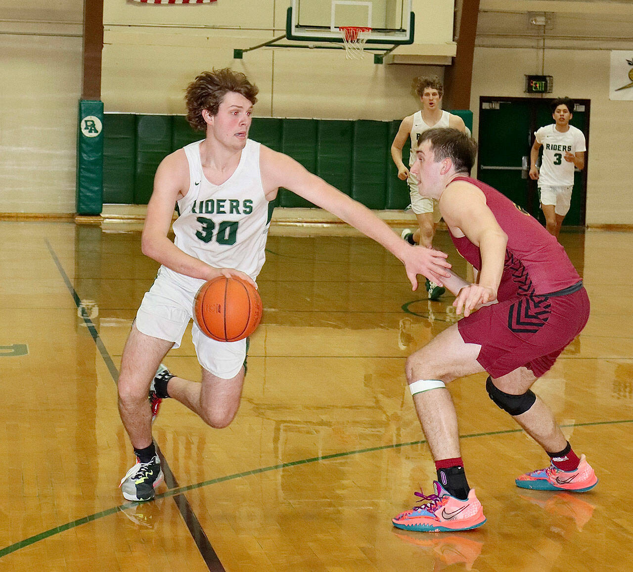 Port Angeles’ Wyatt Dunning drives arounda Kingston defender Tuesday night. Dunning had 31 points on the night and hit six 3-pointers. (Dave Logan/for Peninsula Daily News)