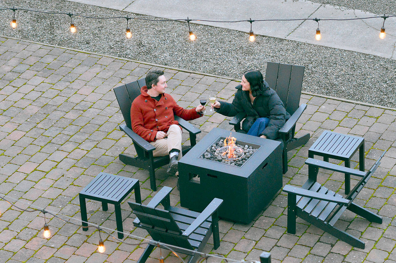 Eric Wennberg and Jessica Jennings, new owners of the Bishop Hotel in Port Townsend, have connected their garden to the indoor wine bar. (Diane Urbani de la Paz/Peninsula Daily News)