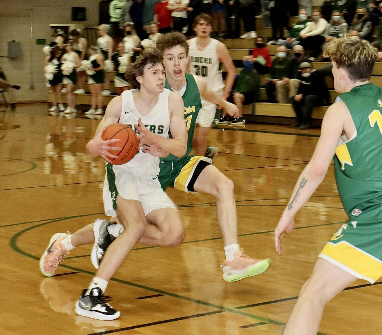 Port Angeles’ Parker Nickerson drives against Sehome’s Grant Kepley on Friday night in Port Angeles. Nickerson scored 11 points in the third quarter to help spark a Roughriders comeback win. (Dave Logan/for Peninsula Daily News)