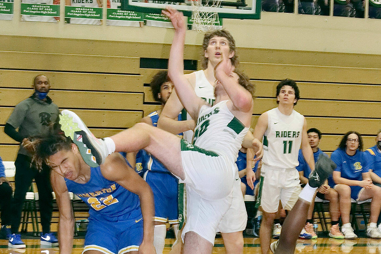 The Knights are falling. PA’s Wyatt Dunning has an off balance shot go in as he parts the Knights defense. in on the play are the Roughriders' John Vaara and Xander Maestas (11). 
John Vaara is just behind and #11 is Xander Maestas is in the background.  dlogan