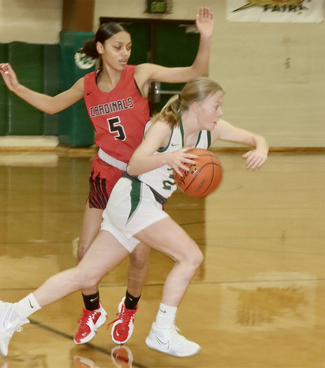 Port Angeles’ Anna Petty drives around Franklin Pierce’s Zionna Barbee (5) in the Roughriders’ 73-28 district playoff win Tuesday night in Port Angeles. With the win, the Riders have already qualified for the state regional round. (Dave Logan/Peninsula Daily News)