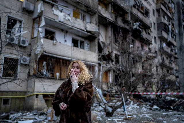 Natali Sevriukova reacts next to her house following a rocket attack the city of Kyiv, Ukraine, on Friday. (Emilio Morenatti/The Associated Press)