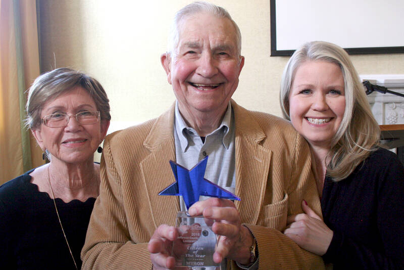 Myron Vogt, center, was honored in April 2019 by the Chamber of Jefferson County as its 2018 Citizen of the Year during a ceremony at the Old Alcohol Plant in Port Hadlock. He was joined by his wife, Valeria, left, and his daughter, Jennifer Molloy. (Brian McLean/Peninsula Daily News file)