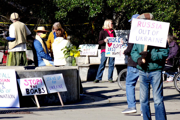 About 25 people gathered at Haller Fountain in Port Townsend on Sunday afternoon to call for peace in Ukraine, Russia and the world. Holding signs and the Ukrainian flag colors, they chanted, “Peace and harmony for the world and ourselves.” (Phil Lusk/For Peninsula Daily News)