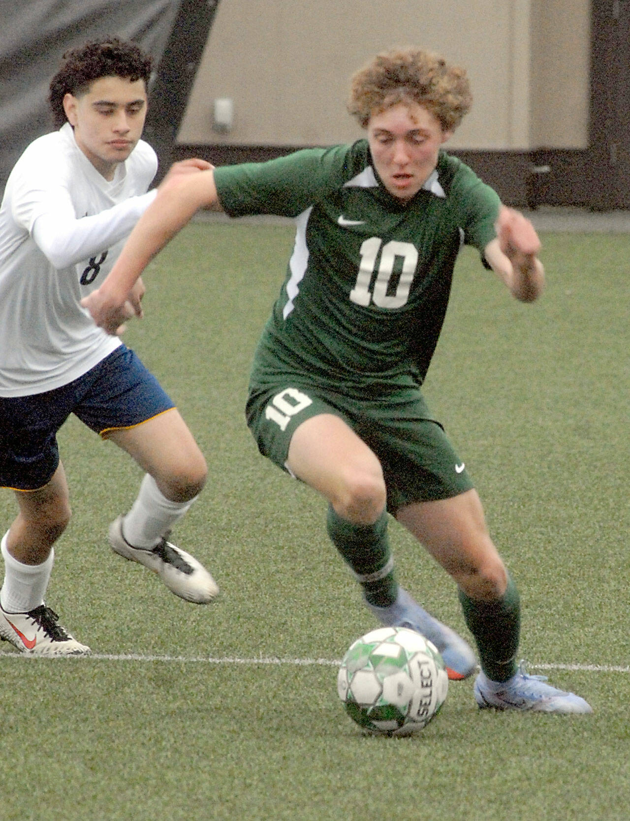 Port Angeles’ Noah Gundersen, right, fends off the defense of Forks’ DeAnthony Davila on Saturday at Peninsula College in Port Angeles. (Keith Thorpe/Peninsula Daily News)