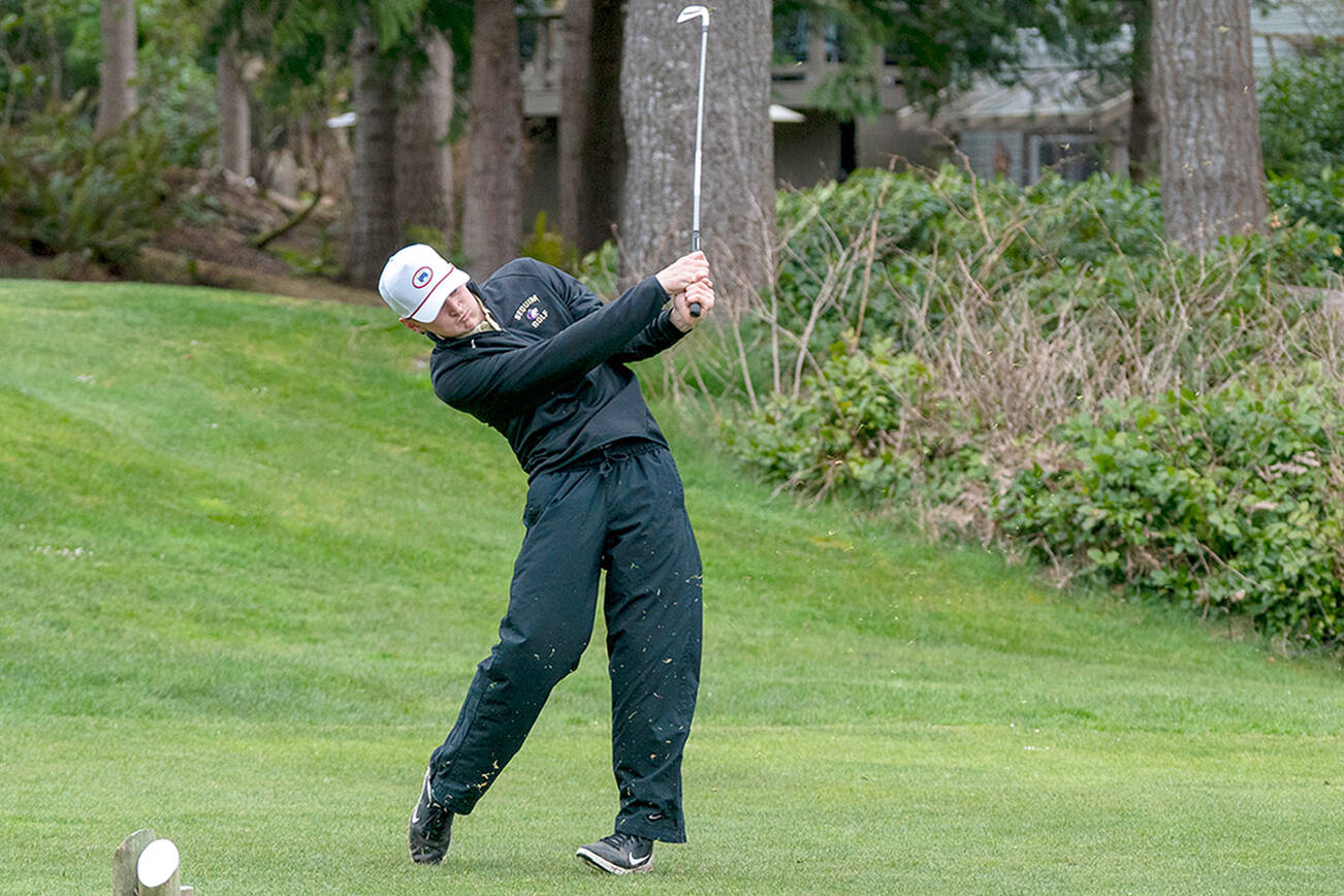 Steve Mullensky/for Peninsula Daily News
Sequim’s Dom Riccobene drives the ball with an iron on the second hole at Port Ludlow Golf Course during a match Thursday against the North Kitsap Vikings.